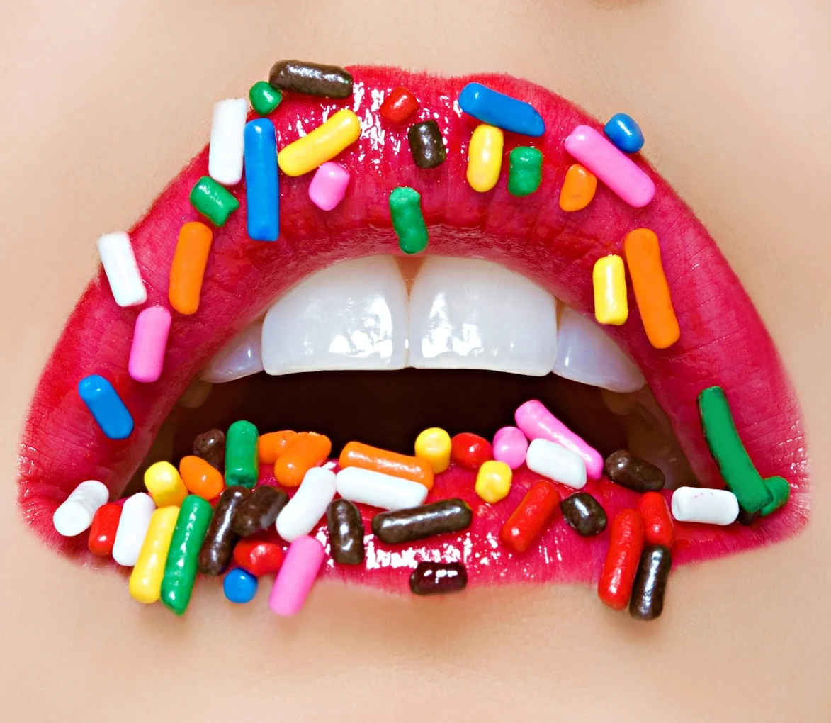 Colorful smile with red lips and candy sprinkles