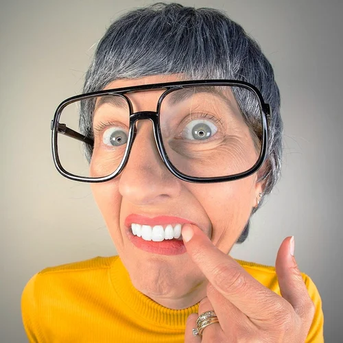 woman pointing to a chipped front tooth