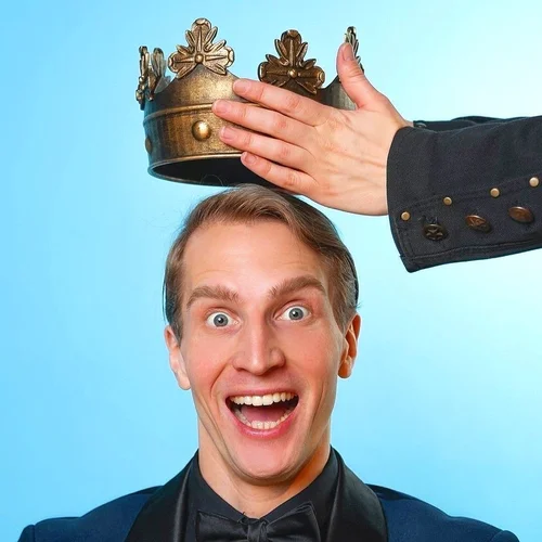 Humorous dental crown image showing a grinning man having a gold king's crown placed on his head