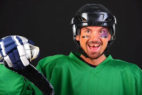 Hockey player smiling with a missing front tooth