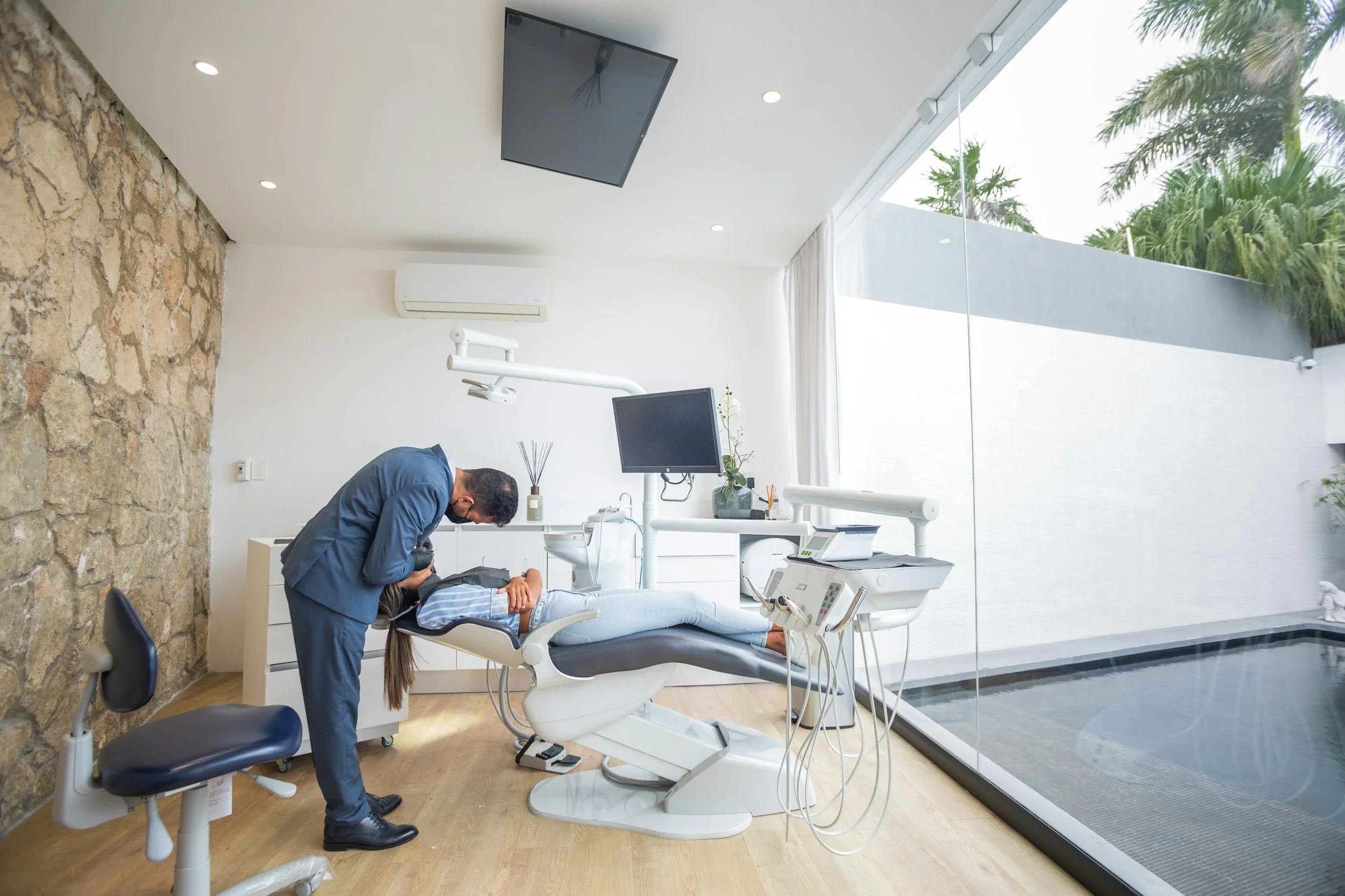 Dentist treating patient in a modern dental treatment room